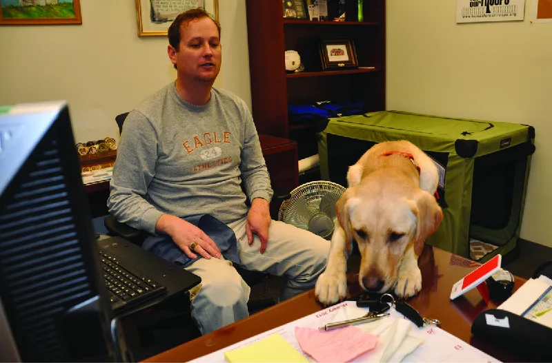 Figure 8.5 A person with a service dog can usually perform all the essential function of the job, with some assistance. (credit: “DSC_004” by Aberdeen Proving Ground/Flickr, CC BY 2.0)