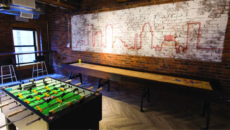 Figure 6.5 Workplace or clubhouse? Some companies offer playful perks in an effort to attract the best employees and increase worker satisfaction. (credit: work by Jason Putsche Photography/Spark Baltimore, CC BY 4.0)