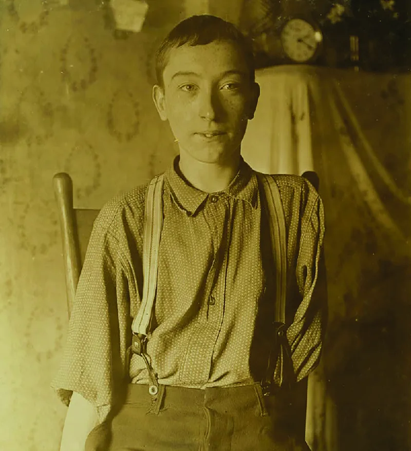Figure 6.3 Harry McShane, who celebrated his sixteenth birthday a month or so before this photo was taken by social reformer and photographer Lewis Wickes Hine, lost his left arm as a result of a workplace injury in May 1908 in Cincinnati, Ohio. McShane had already been working in the factory for more than two years. Before federal safety regulations (such as OSHA and FLSA), catastrophic injuries on the job were common, as was the presence of children in the workforce. McShane received no compensation for his injuries. (credit: modification of “Lewis Wickes Hines - Harry McShane 1908” by “Fordmadoxfraud”/Wikimedia Commons, Public Domain)