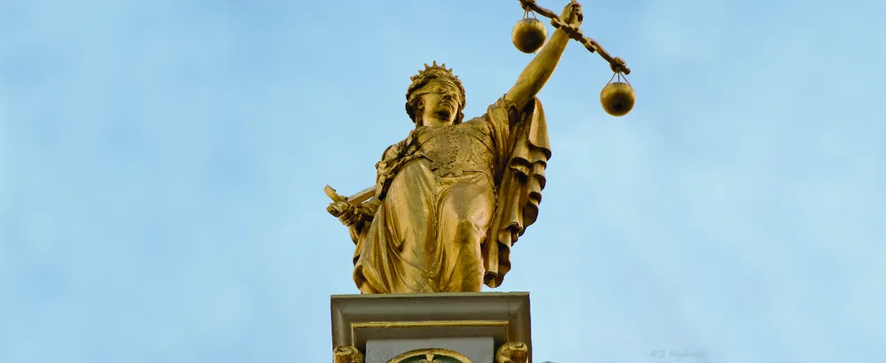 Figure 2.1 Their accuracy and practical use in the marketplace made scales, held aloft here by the figure of Justice in Bruges, Belgium, a common symbol in jurisprudence and law in the East and the West. Even today, the concept of counterbalancing different ideas and philosophies underlies many approaches to the law and ethics. (credit: modification of “Golden Lady Justice” by Emmanuel Huybrechts/Flickr, CC BY 2.0)